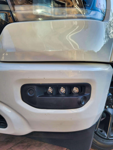 Close-up of installed RAM Rebel fog light kit 2019-2024 showing triple LED RAM Rebel fog light in front bumper