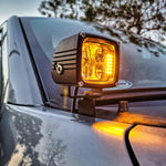 up close view of a 3.25in ditch light pod on a ford f150 with amber backlights