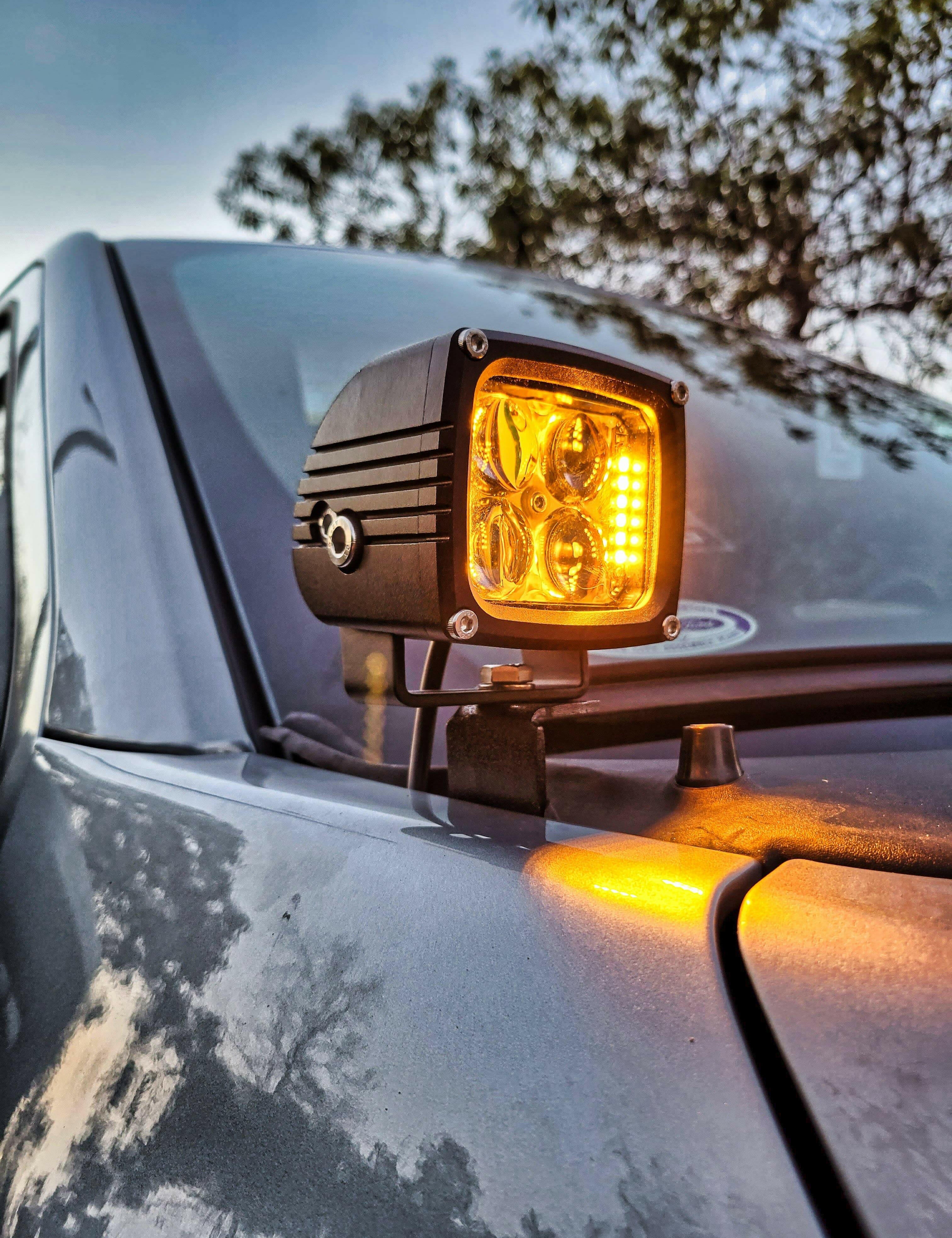 up close view of a 3.25in ditch light pod on a ford f150 with amber backlights