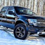 2010-2014 Ford Raptor Gen 1 truck showcasing Ford Raptor Gen 1 fog light kit in snowy forest setting