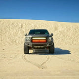 gray ford raptor generation 2 in the dessert with 2 40in behind the grille light bars color white and amber 
