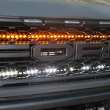 u[ close view of 2021 22021 2022 2023 ford raptor generation 3 grille with off roading light bars behind