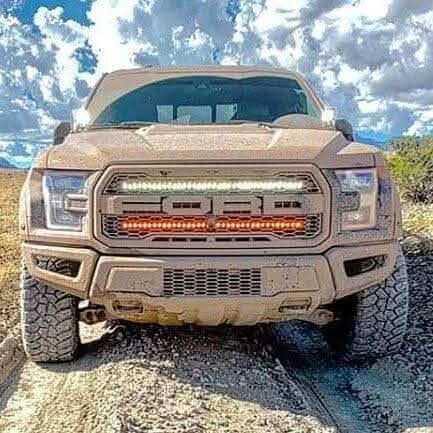 Off-road 2017-2020 truck equipped with Ford Raptor Gen 2 Light Bars dual 40s LED grille kit on rocky trail