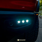 RAM Rebel fog light kit 2019-2024 with triple LED pods illuminated on front bumper at dusk
