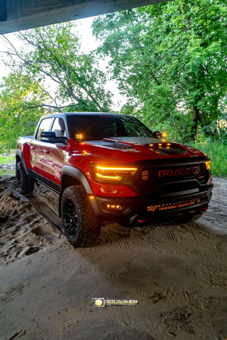 Red RAM 1500 Rebel with installed RAM Rebel Light Bar under bridge, showcasing 40in slim LED front light bar upgrade