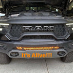 RAM Rebel Light Bar installed on 2019-2024 RAM 1500 Rebel front bumper glowing amber with hood open