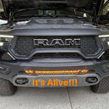 RAM Rebel Light Bar installed on 2019-2024 RAM 1500 Rebel front bumper glowing amber with hood open