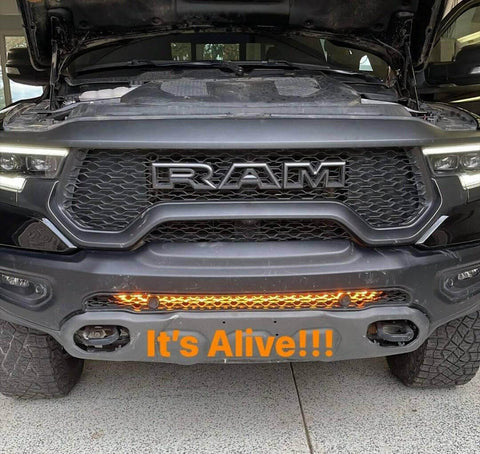 RAM Rebel Light Bar installed on 2019-2024 RAM 1500 Rebel front bumper glowing amber with hood open