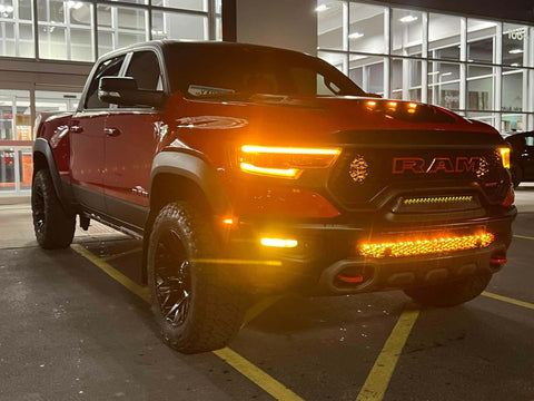 RAM Rebel Light Bar single 40in slim front bumper LED on red RAM 1500 Rebel 2019-2024 at night in parking lot