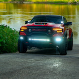 Red RAM 1500 with RAM Rebel Light Bar single 40in slim light bar illuminated at river boat ramp front view