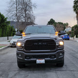 2025+ RAM 2500 3500 Ditch Lights with dual color amber DRL glowing on front of black RAM HD truck on residential street