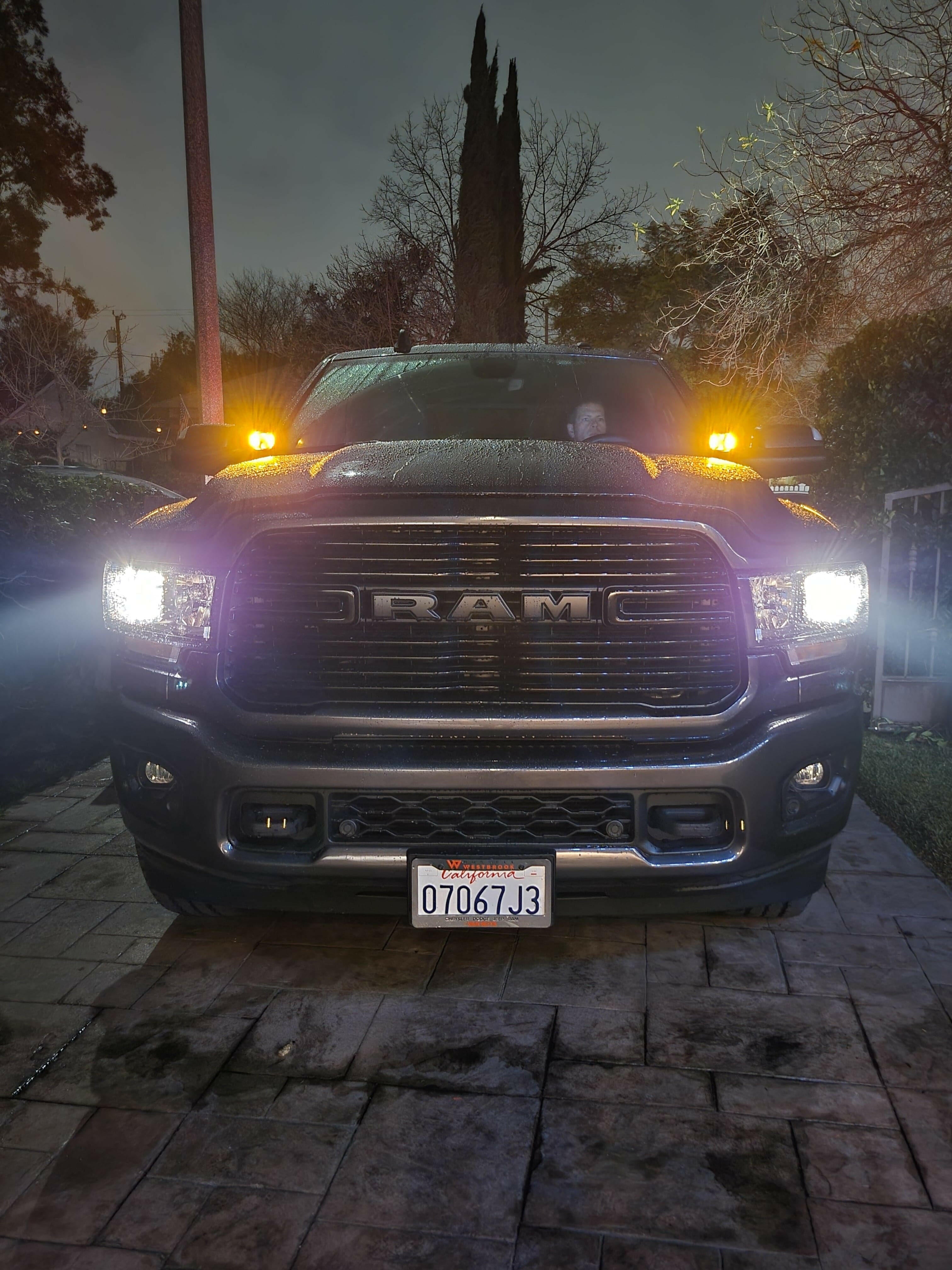 2025+ RAM 2500 3500 Ditch Lights with white beams and amber DRL backglow illuminated at night