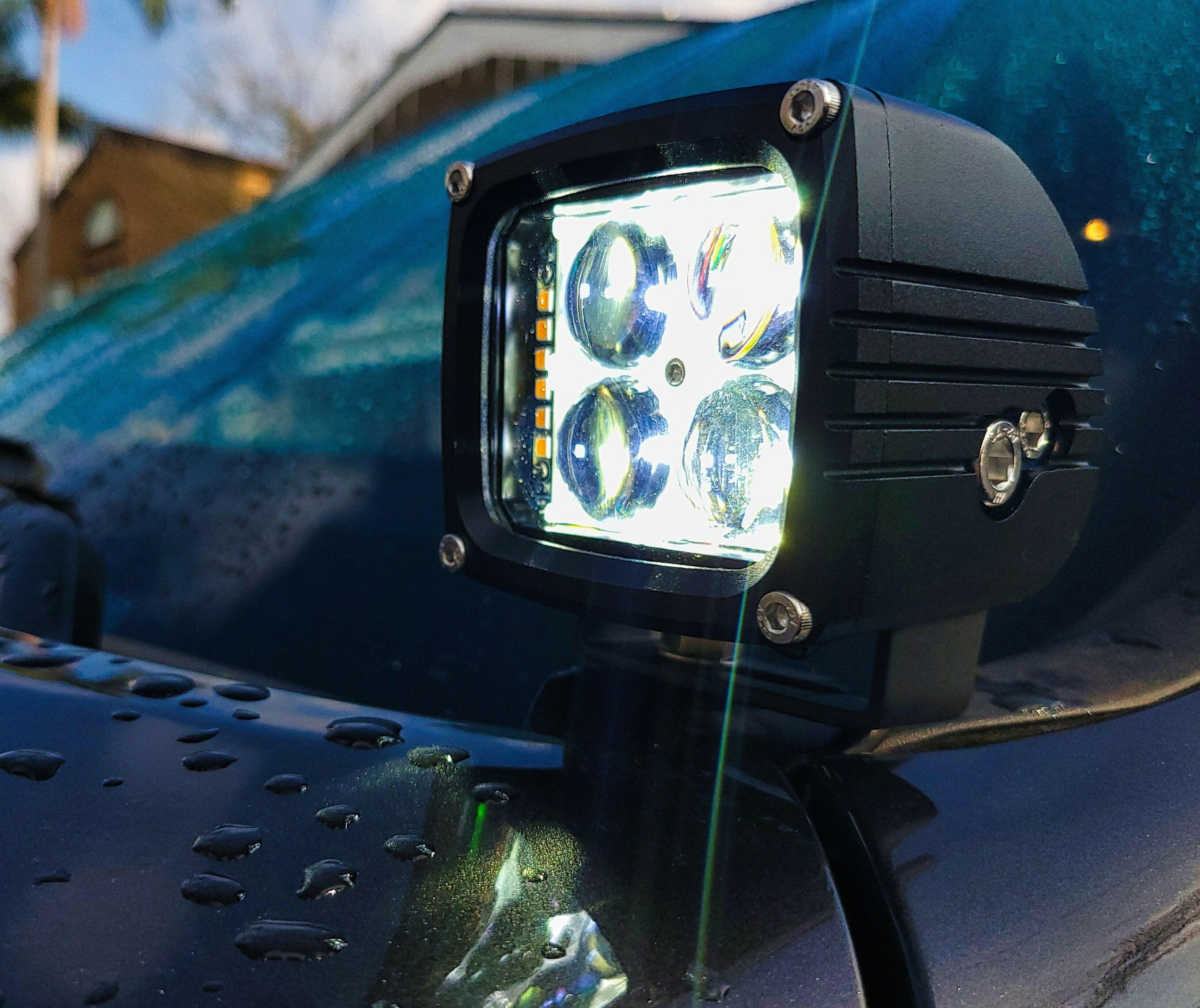 2025+ RAM 2500 3500 Ditch Lights dual color LED ditch light with bright white beam and amber DRL backglow mounted on truck hood